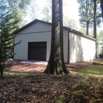 a 30x40 workshop with porch for sale in reading pa seen through the trees
