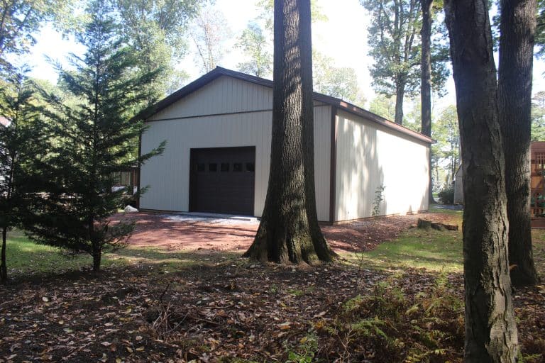 a 30x40 workshop with porch for sale in reading pa seen through the trees