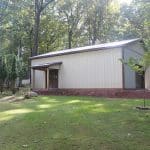 view of the 30x40 workshop with porch for sale in reading pa with trees and house in the background