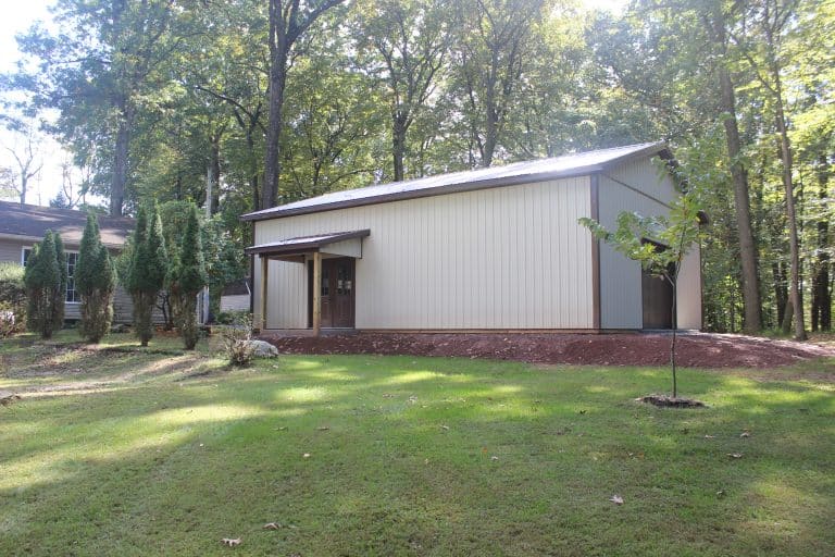 view of the 30x40 workshop with porch for sale in reading pa with trees and house in the background