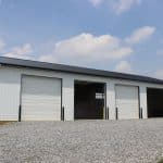 shot of white and black 4 garage door 40x80 ag building for sale
