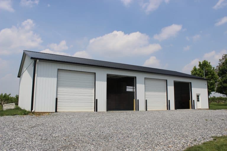 shot of white and black 4 garage door 40x80 ag building for sale