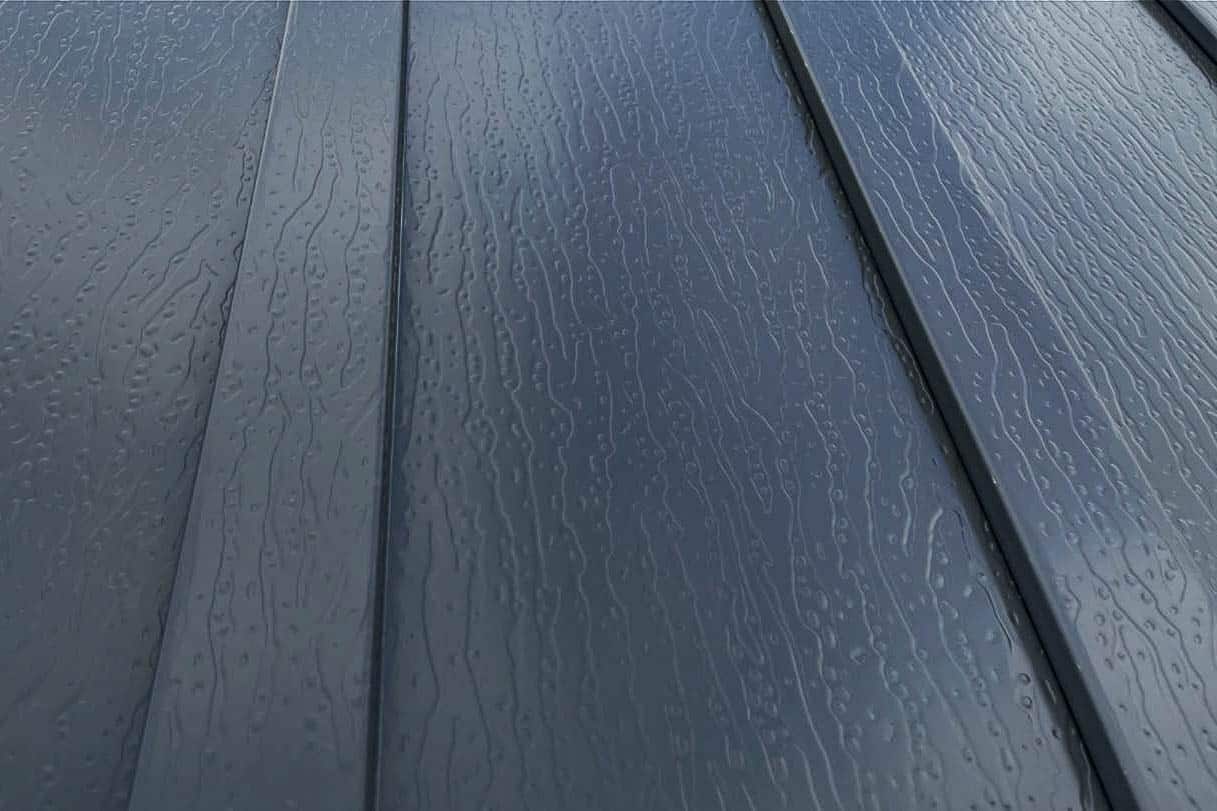 close-up of new holland supply board and batten metal siding with textured painted finish and raised vertical batten profile.