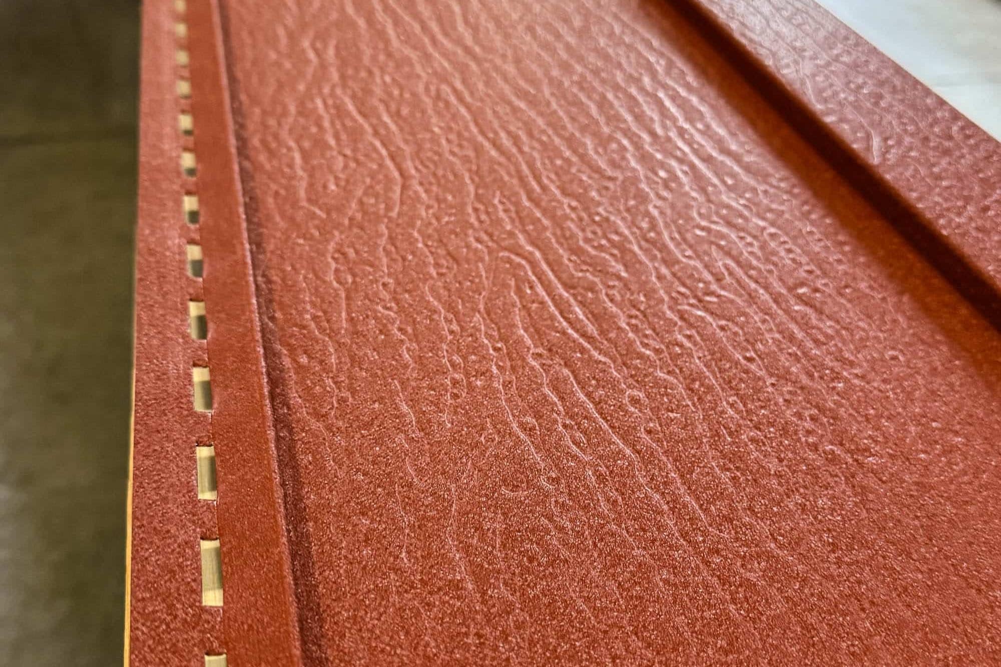 close-up of textured metal board and batten siding panel