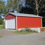 sideview of a red tractor shed for sale in douglassville pa