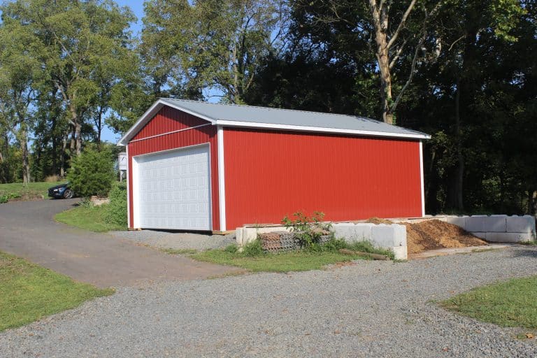 sideview of a red tractor shed for sale in douglassville pa