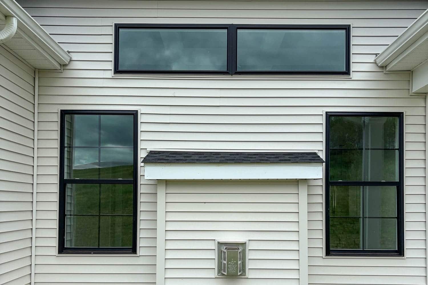black-framed seven d vinyl windows installed on a white post-frame home exterior